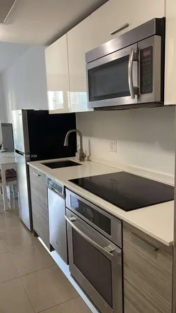 a living room with a flat screen tv and couches