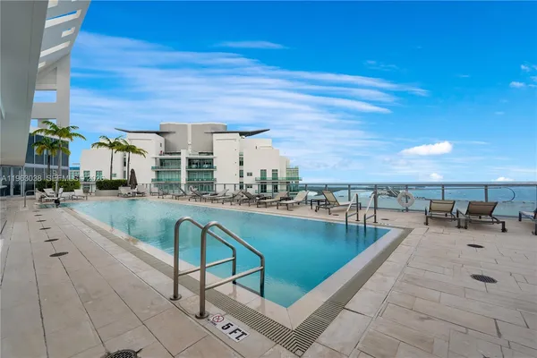 a view of swimming pool with outdoor seating and a couch