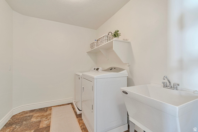 1288 North Horizon View Loop Elk Ridge, UT 84651 - Photo 27 of 40 Laundry room featuring stone finish flooring and washer and dryer
