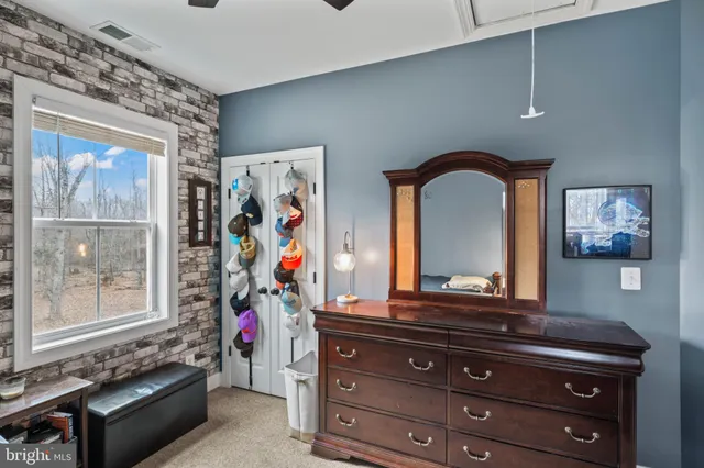 a living room with furniture a wooden floor and potted plant