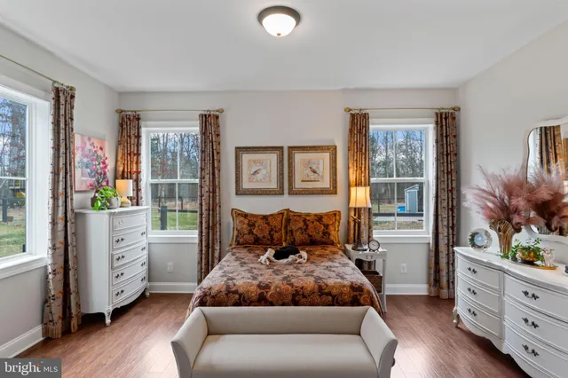 a dining room with furniture a chandelier and wooden floor