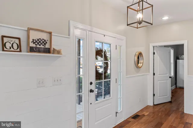 a view of a dining room with furniture wooden floor and chandelier