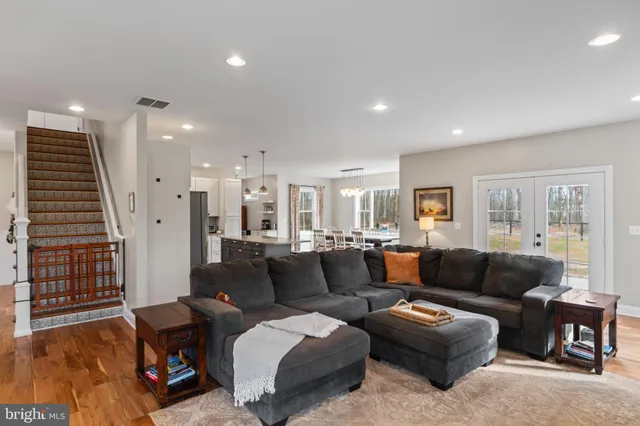 a living room with lots of furniture and kitchen view
