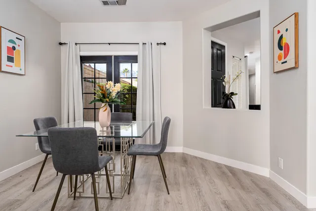 a view of a dining room with furniture and wooden floor