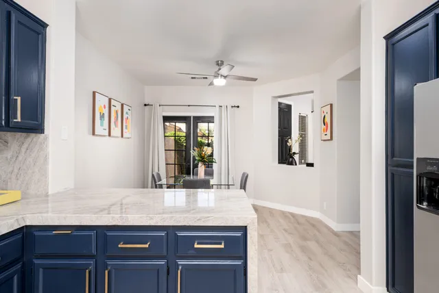 a kitchen with granite countertop a refrigerator and a sink