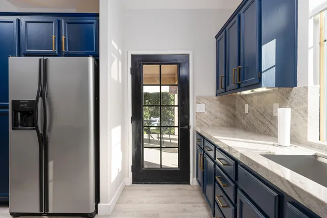 wooden floor with windows and chandelier in a room