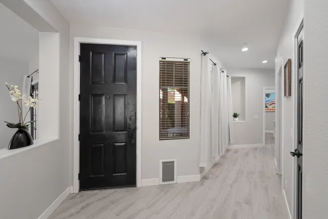 a bedroom with a bed dresser and a flat screen tv