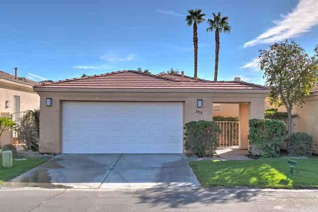 a view of a house with a yard and plants