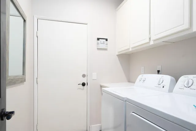 a view of a patio with table and chairs and floor to ceiling window and yard