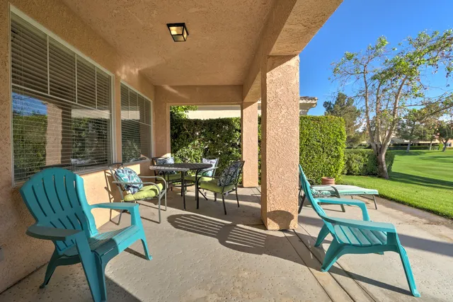 a view of a two chairs in a backyard