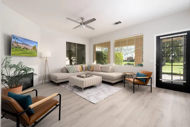 a living room with furniture and a large window