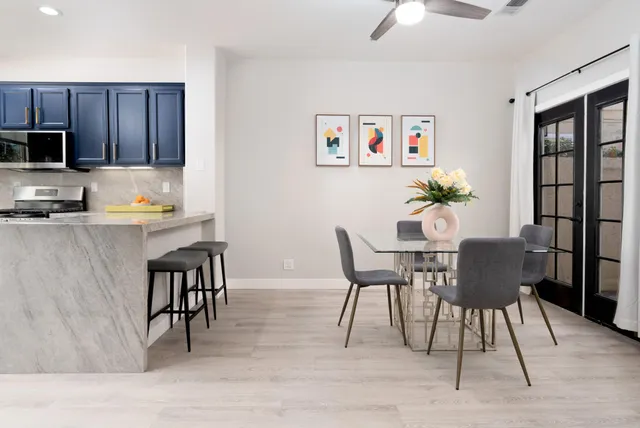 a dining room with furniture and wooden floor