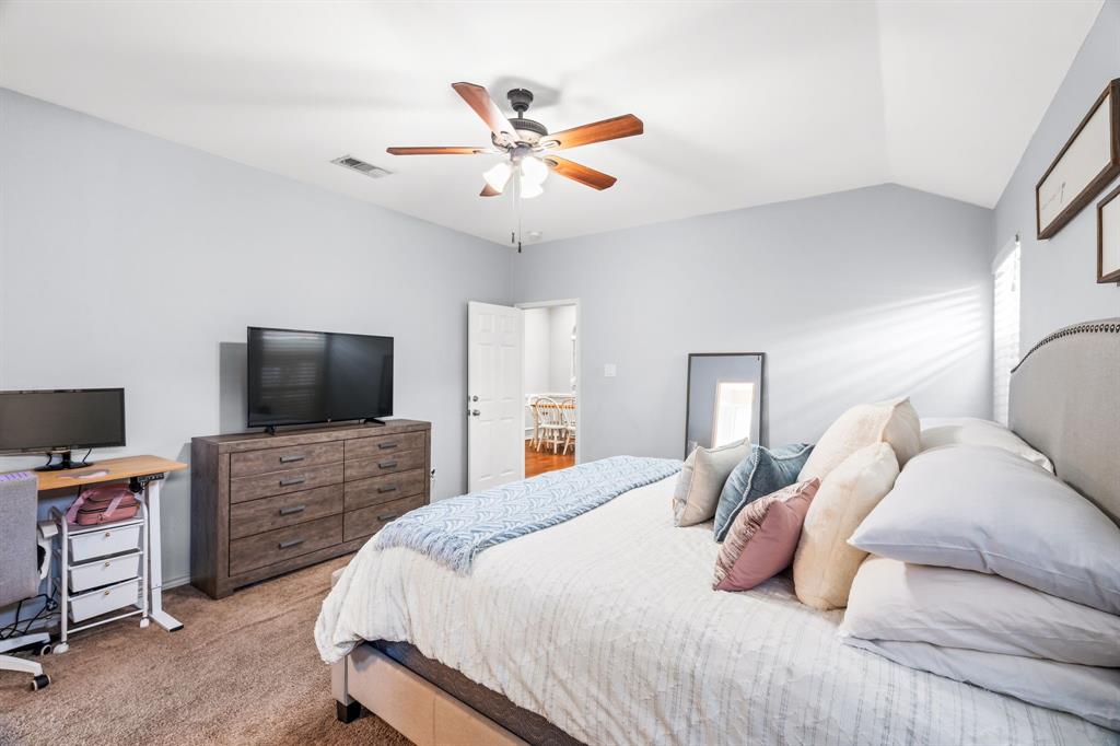 2302 Randi Road Rowlett, TX 75088 - Photo 15 of 33 a bedroom with a bed and a flat screen tv