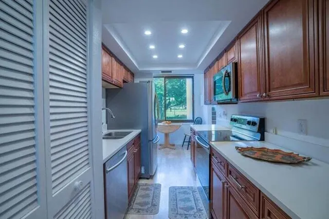 a kitchen with windows and refrigerator
