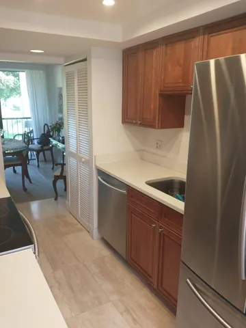 a kitchen with stainless steel appliances granite countertop a refrigerator and a sink