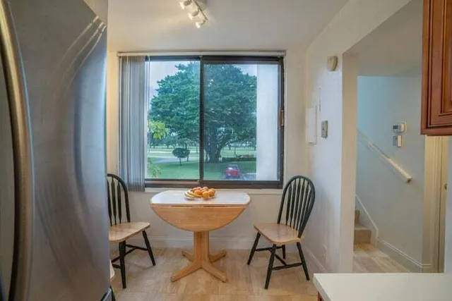 a view of a dining room with furniture window and outside view