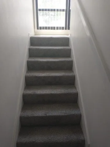 a view of staircase with white walls