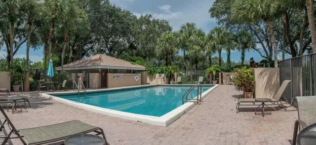 an outdoor space with swimming pool and furniture