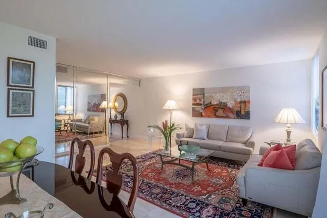 a living room with furniture and a lamp