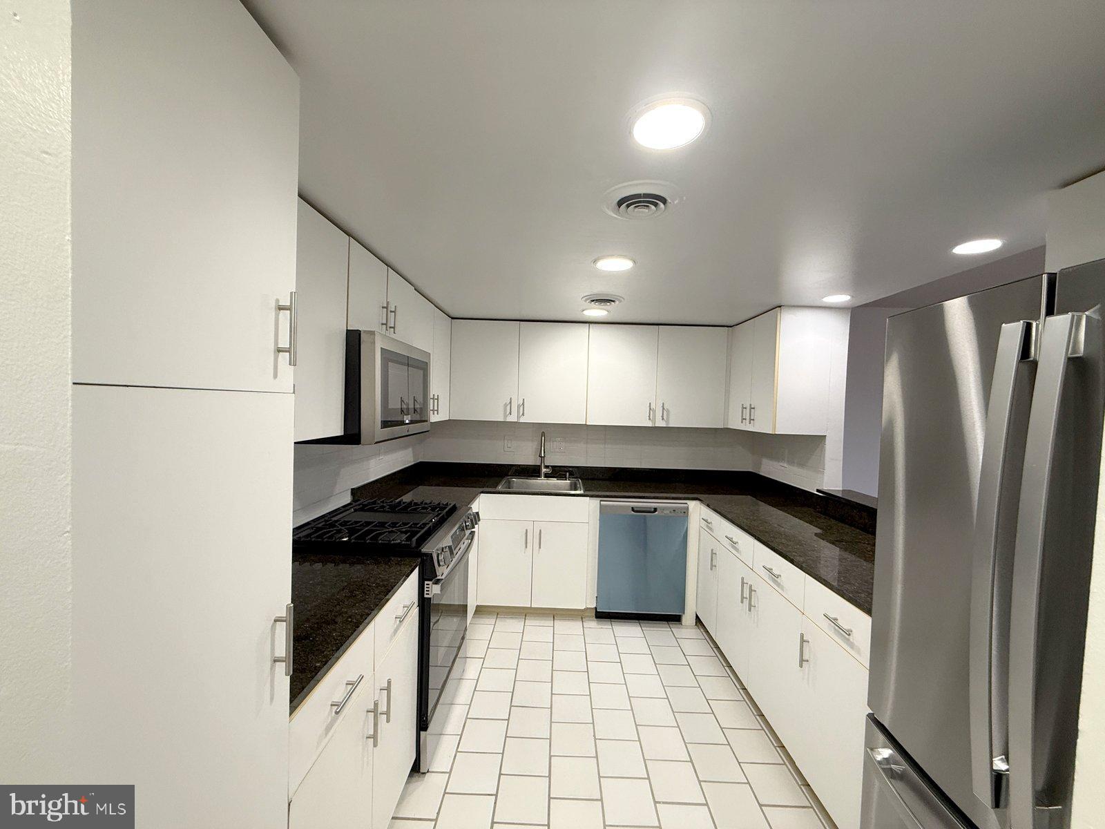 606 Cooper Landing Road, Unit B6F Cherry Hill, NJ 08002 - Photo 2 of 11 a kitchen with granite countertop a refrigerator and a sink