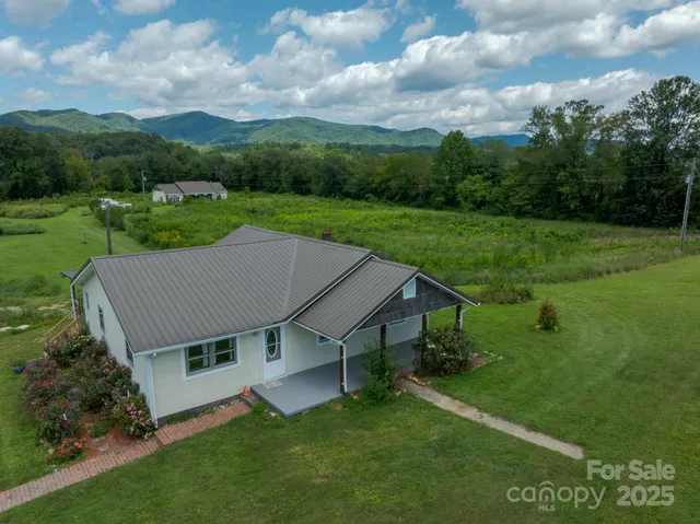 aerial view of a house with a yard table and chairs