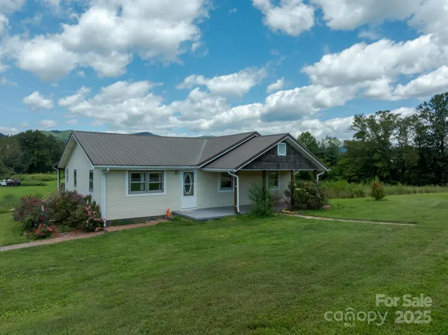 a view of a house with yard and a garden