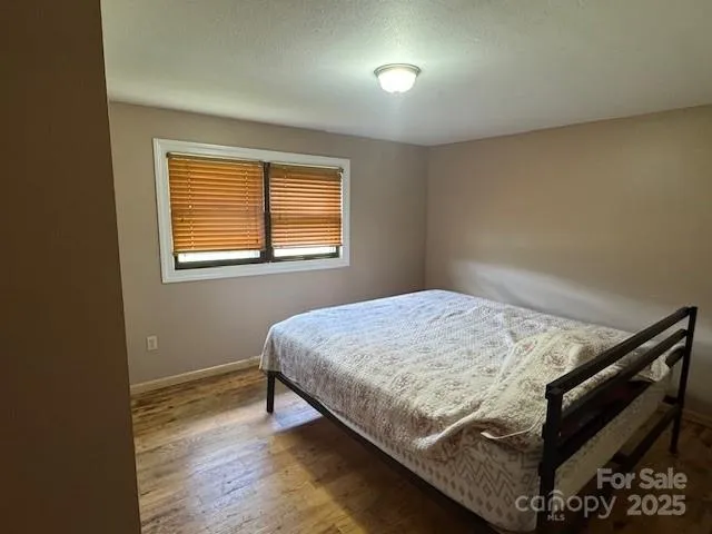 a bed sitting in a bedroom next to a window