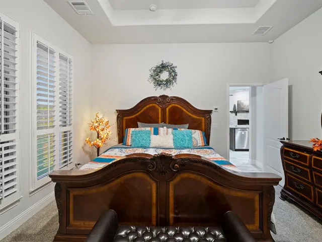 a bed sitting in a bedroom next to a window