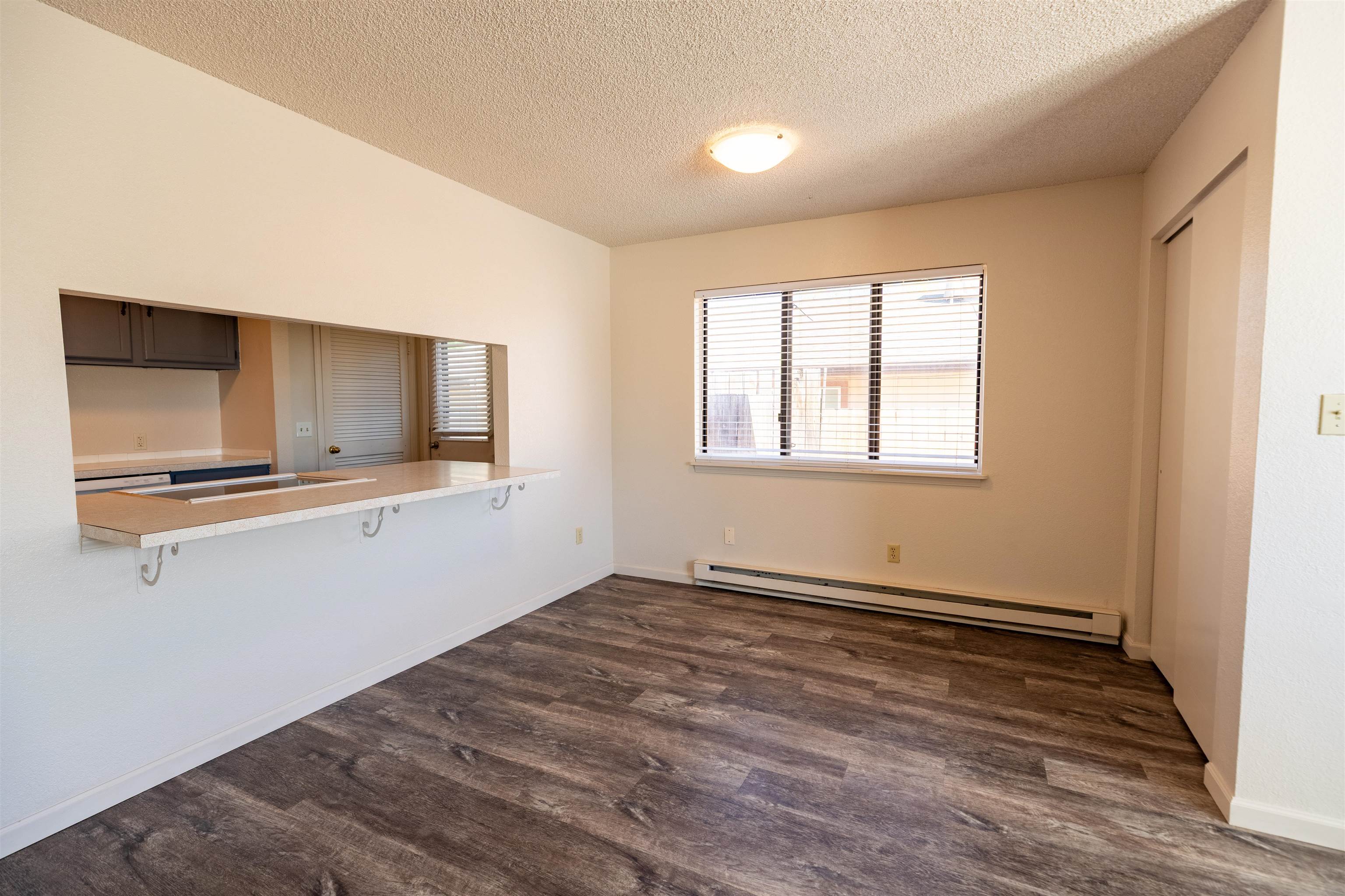 239 South Elm Street, Unit A Fruita, CO 81521 - Photo 5 of 22 a view of an empty room with wooden floor and a window