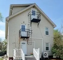 a front view of a house with large windows
