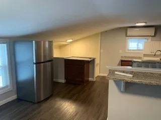 a kitchen with stainless steel appliances granite countertop a refrigerator and a stove