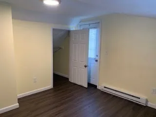 an empty room with wooden floor