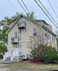 a house that has a tree in front of it