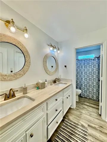a bathroom with a double vanity sink and mirror