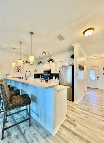 a kitchen with stainless steel appliances granite countertop a sink and a refrigerator