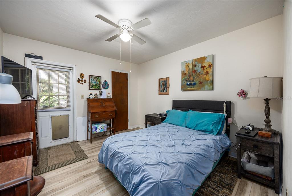 11440 Southwest Archer Road Gainesville, FL 32608 - Photo 12 of 44 a bedroom with a bed and a flat screen tv