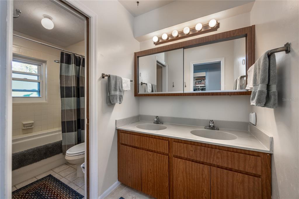 11440 Southwest Archer Road Gainesville, FL 32608 - Photo 13 of 44 a bathroom with a sink a toilet and shower