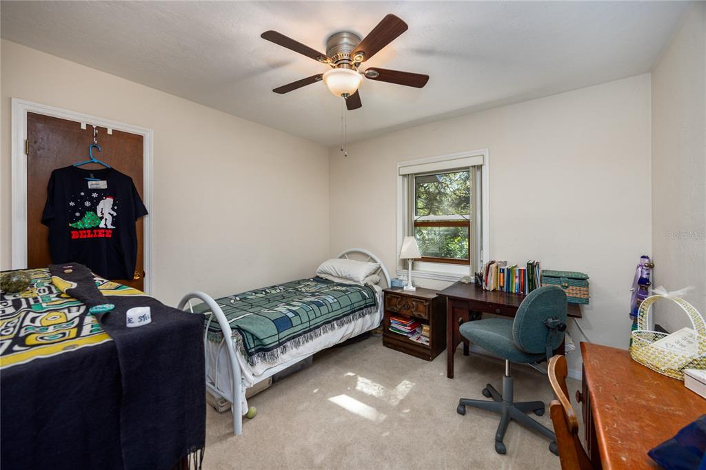 11440 Southwest Archer Road Gainesville, FL 32608 - Photo 15 of 44 a bedroom that has a bed and a chair in it