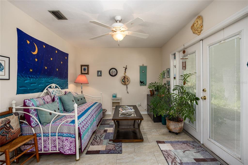 11440 Southwest Archer Road Gainesville, FL 32608 - Photo 16 of 44 a bedroom with furniture and a chandelier