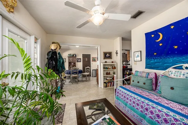 a bedroom with furniture and a potted plant