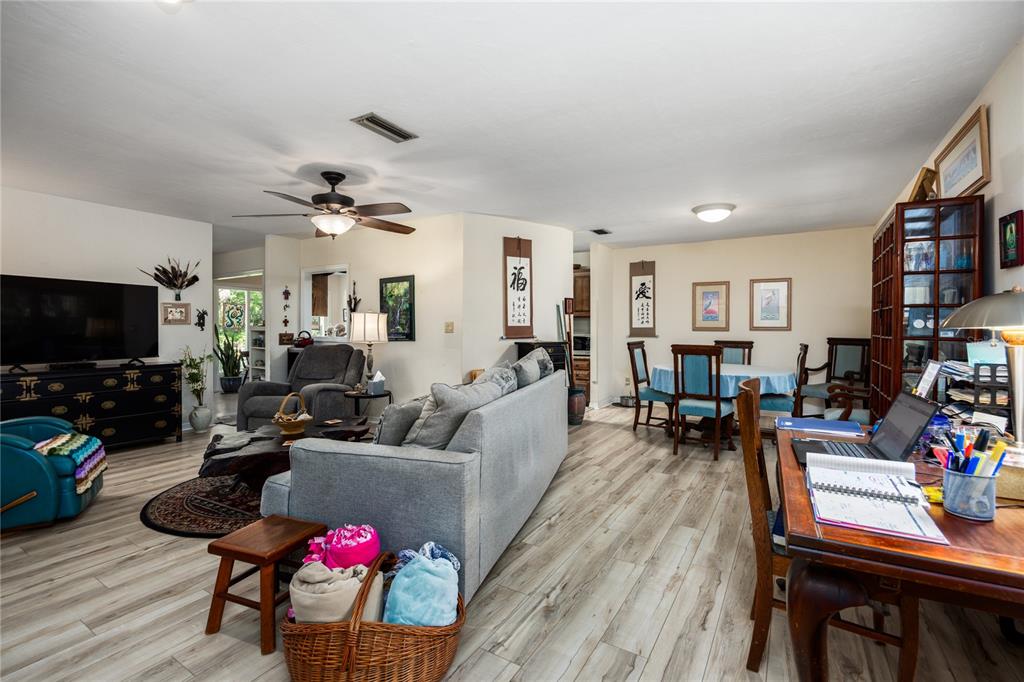 11440 Southwest Archer Road Gainesville, FL 32608 - Photo 2 of 44 a living room with furniture and a flat screen tv