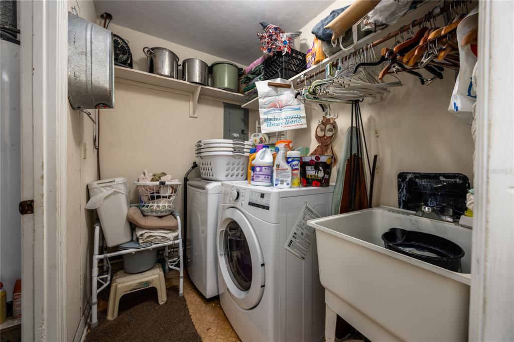 11440 Southwest Archer Road Gainesville, FL 32608 - Photo 23 of 44 a utility room with dryer washer and a view of living room