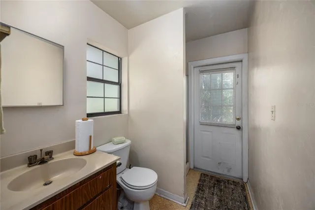a bathroom with a sink toilet and vanity