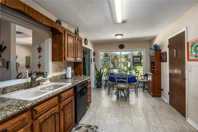 a kitchen with granite countertop lots of counter top space and dining table