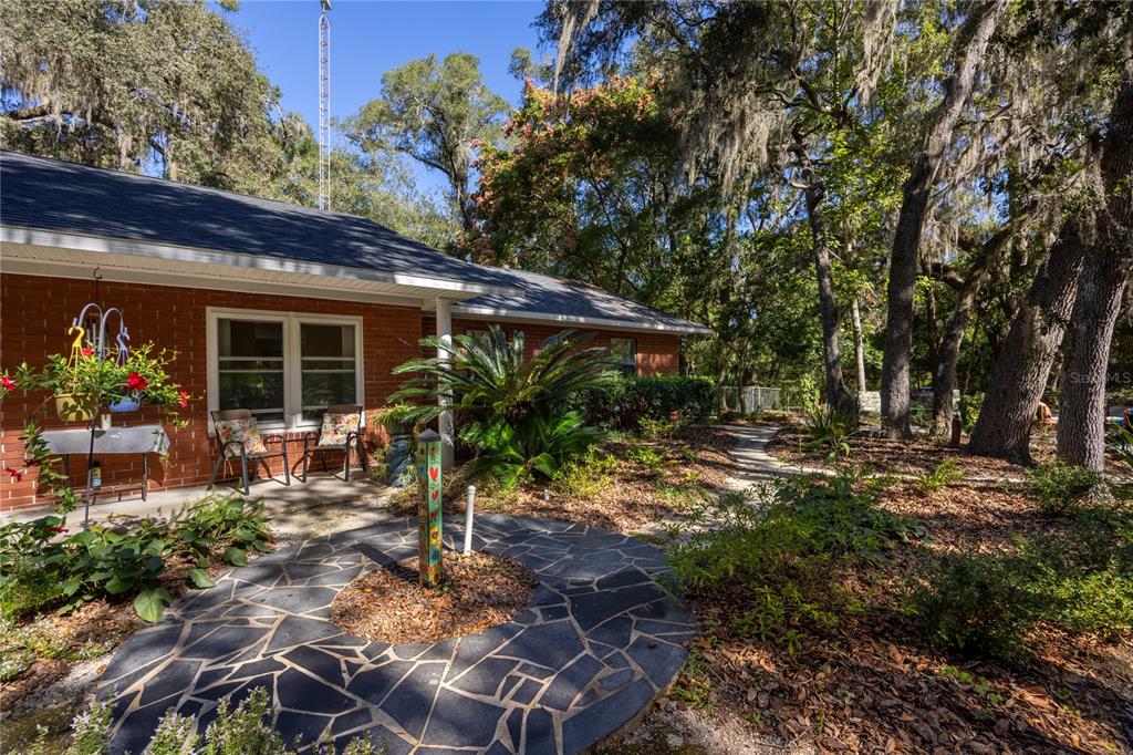 11440 Southwest Archer Road Gainesville, FL 32608 - Photo 35 of 44 a backyard of a house with yard and outdoor seating