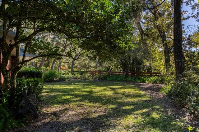 a view of a patio with table and chairs and potted plants