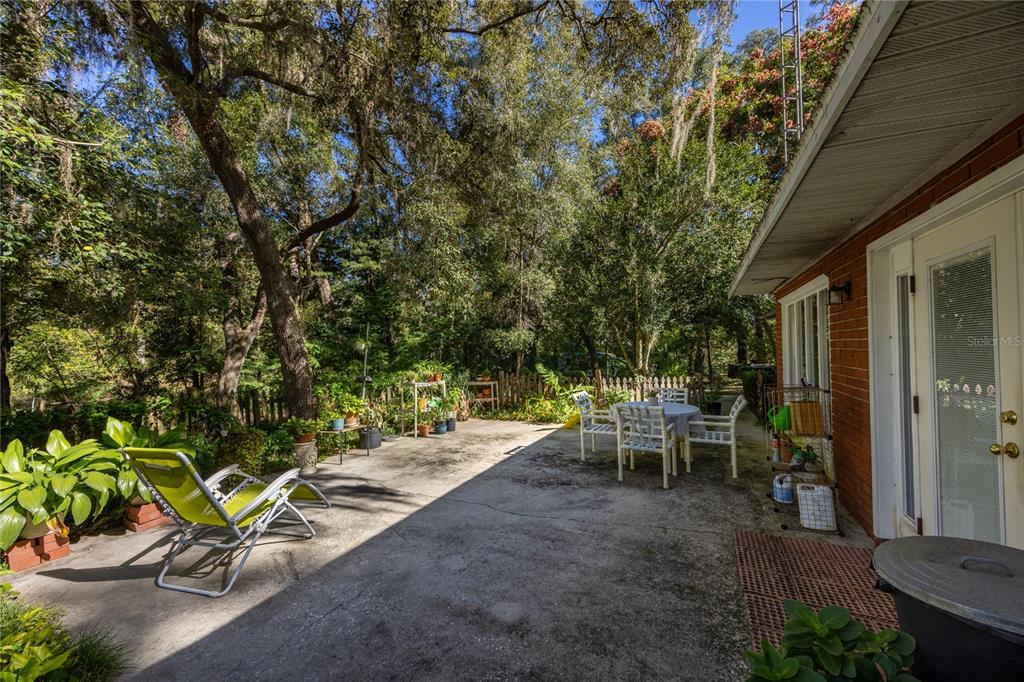 11440 Southwest Archer Road Gainesville, FL 32608 - Photo 39 of 44 a view of a patio with table and chairs and potted plants