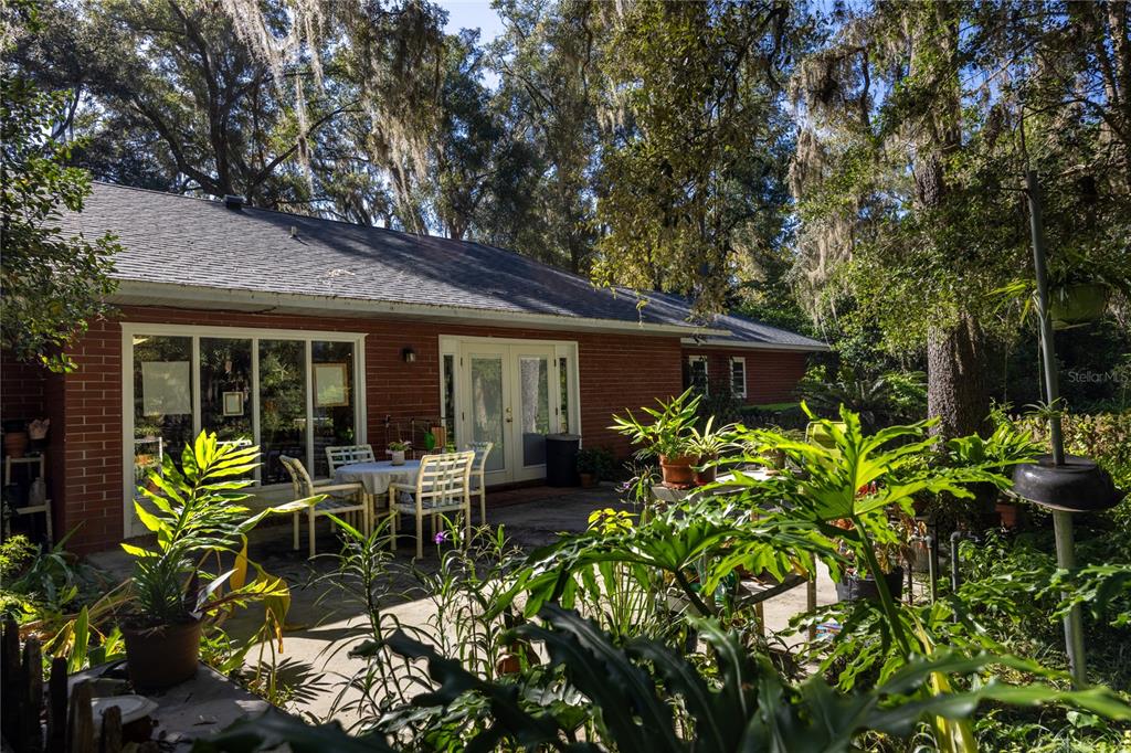 11440 Southwest Archer Road Gainesville, FL 32608 - Photo 41 of 44 a house with a table and chairs in patio
