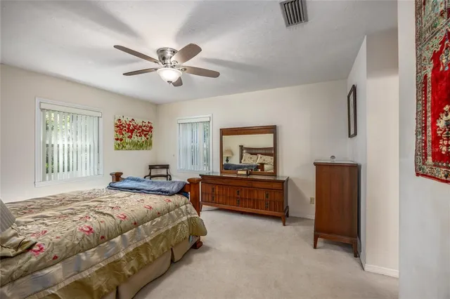 a bedroom with a bed dresser and a window