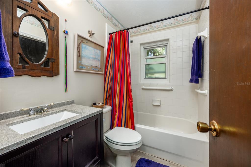 11440 Southwest Archer Road Gainesville, FL 32608 - Photo 10 of 44 a bathroom with a sink a toilet and a mirror